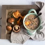 creamy vegan mushroom soup on wooden tray