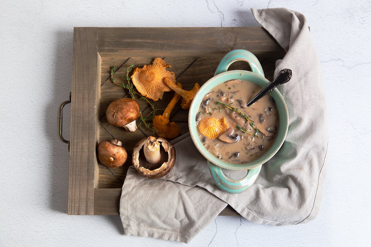 creamy vegan mushroom soup on wooden tray