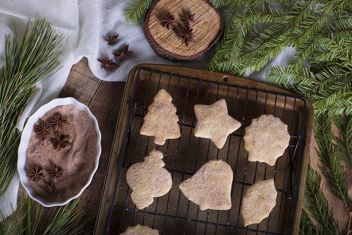 biscochitos on cooling rack and baking sheet.